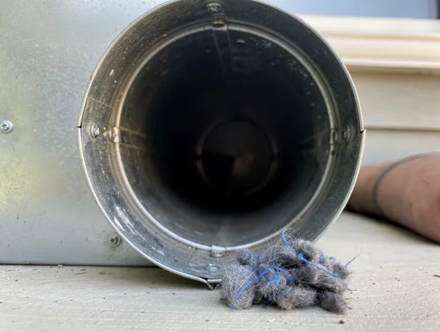 Port Charlotte Dryer Vent Cleaning technician using specialized equipment to clear severe dryer vent blockage in Port Charlotte